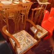 A C19th mahogany elbow chair with pierced splat back and tapestry seat and the matching side chair
