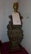 A Chinese bronze table lamp with ring handles