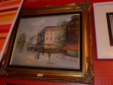 A Continental oil on canvas street scene within carved giltwood frame