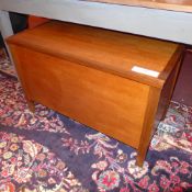 A teak blanket box of simple form on square section supports