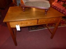 An oak side table fitted two drawers and raised on stretchered supports