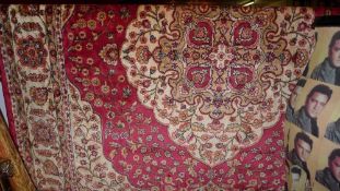 A Persian Kilim design carpet the rouge field with central pendant motifs and extensive gold