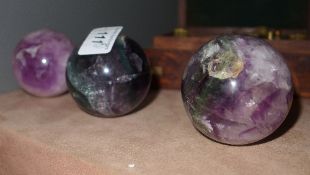 A set of three amethyst balls