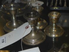 Two pairs of silver dwarf candlesticks