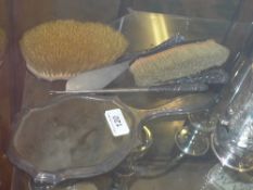 A hallmarked silver dressing set comprom