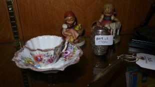 A pair of Hummel figures and propelling