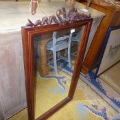 A mahogany rectangular wall mirror the bevelled plate with carved crest