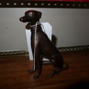 A bronze cast of a recumbent greyhound
