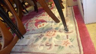 A Chinese carpet with fuchsia ground, ce