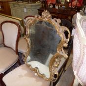 A profusely carved gilded shield shape pier mirror (a/f)