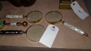 A set of four magnifying glasses