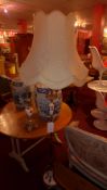A brass and faux alabaster standard lamp raised on paw supports and a similar table lamp