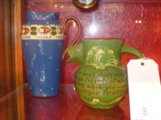 An earthenware mottoware jug with a spout in the form of a fishes head together with an Aller ware