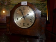 A C1930`s oak mantel clock with carved detail made in Enfield