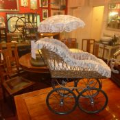A childs toy pushchair and doll