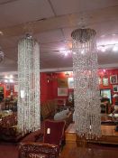 A pair of contemporary ceiling lights with strings of lustres