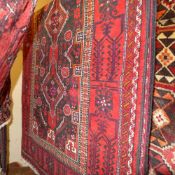 A fine North East Persian zabul belouch rug 245 x 120 cm repeating pole medallion with animal motifs