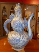 A Chinese blue and white tea pot of large size with dragon form handle and decorated with fish
