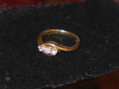 A ladies 9ct gold and diamond crossover ring