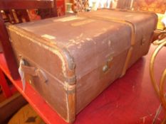 A brown travelling trunk with wooden bracing