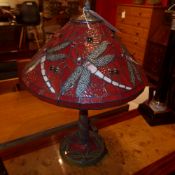A Tiffany style table lamp with stained leaded glass shade decorated with butterflies