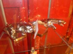 A pair of replica steel Jaguar car mascots