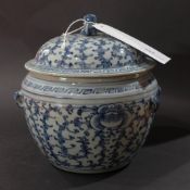 A Chinese blue and white lidded bowl with floral decoration and Dog of Fo surmount