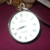 A faux Omega bulls eye desk clock with winding movement