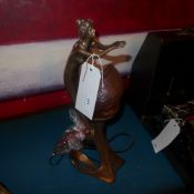 An Art Deco style lamp in the form of a maiden with frosted glass shell form shade