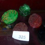 A collection of four various Chinese carved pendants