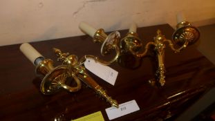 A pair of brass twin sconce wall lights