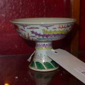 A Chinese porcelain stem cup decorated with a dragon and a phoenix chasing a pearl