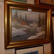 A Continental oil on canvas snowscape of a river flowing past houses signed indistinctly in a gilded