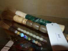 A collection of four various Chinese calligraphy brushes with semi precious stone handles