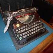 A vintage Continental Model typewriter in case