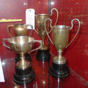 A collection of four silver plated trophies raised on black bases two awarded at Walford darts