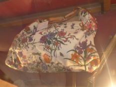 A ladies Gucci handbag with floral fabric and tan leather detail