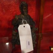 A Chinese bronze figurine of a warrior on a throne