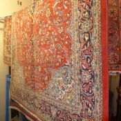 A fine North West Persian Sarouk rug 237 x 135 cm central pole medallion on a terracotta field