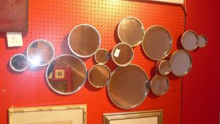 A contemporary wall mirror with multiple circular mirror plates within gilt frame