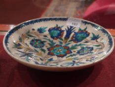 An Iznik plate decorated with flowers in the traditional manner