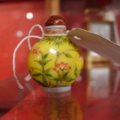 A Chinese hand painted Peking glass snuff bottle decorated with flowers