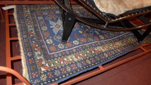 A Persian flatweave rug the dark blue ground decorated with repeating motifs in a triple border