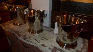 A set of three twin handled oval silver plated wine coolers