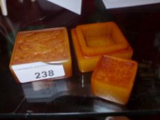 A Chinese soapstone seal within a soapstone box having carved detail of a crane with a fish in its