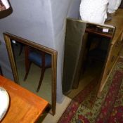 A carved gilded wall mirror and a similar hall mirror