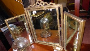 A giltwood triple dressing mirror with ribbon surmount