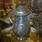 A silver plated embossed stein