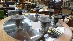 A set of six cast iron miniature urns
