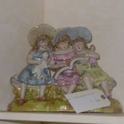A Dresden style figure group of girls on a bench
